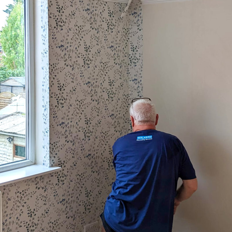 Decorator hanging wallpaper